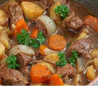 Close up of Irish Stew with meat, potatoes, carrots, onions and garnish