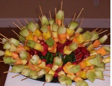 Example of a watermelon rind being used as a display for fruit skewers