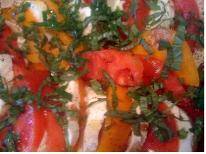 Red and yellow tomatoes with basil blossoms salad