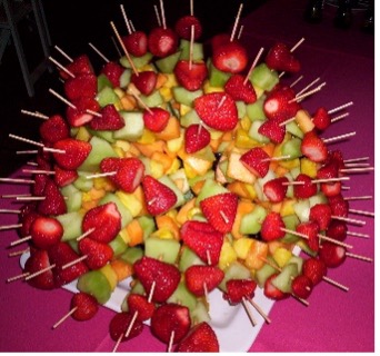 Example of fruit skewers poked into half of a watermelon rind