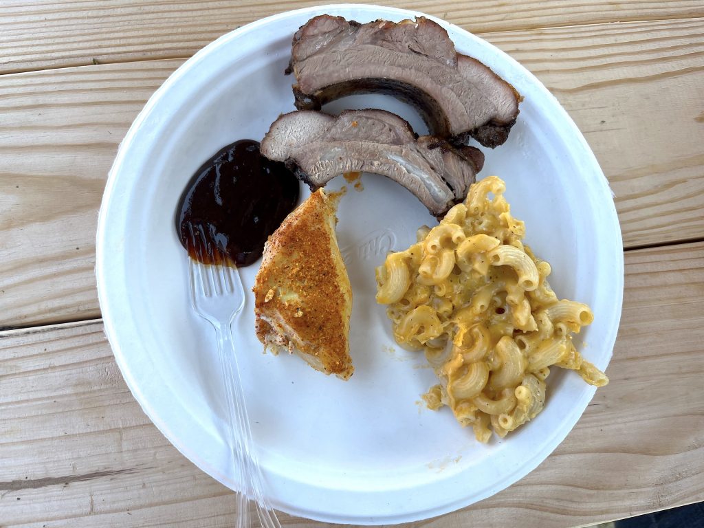 Lunch plate with barbecue ribs, chicken, macaroni and cheese, and homemade barbecue sauce.