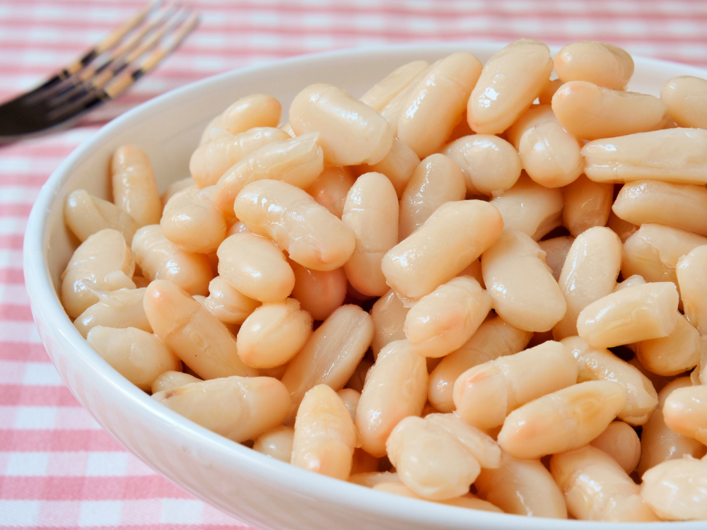 A bowl of plump, creamy white beans, cooked to perfection.