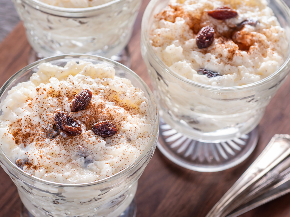 An image of a bowl of creamy rice pudding with a generous topping of plump and juicy craisins.