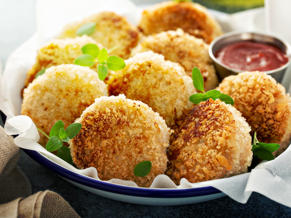 Image of golden-brown fish patties made with flaky white fish, breadcrumbs, and herbs, and are crispy on the outside with a moist and flavorful interior. 