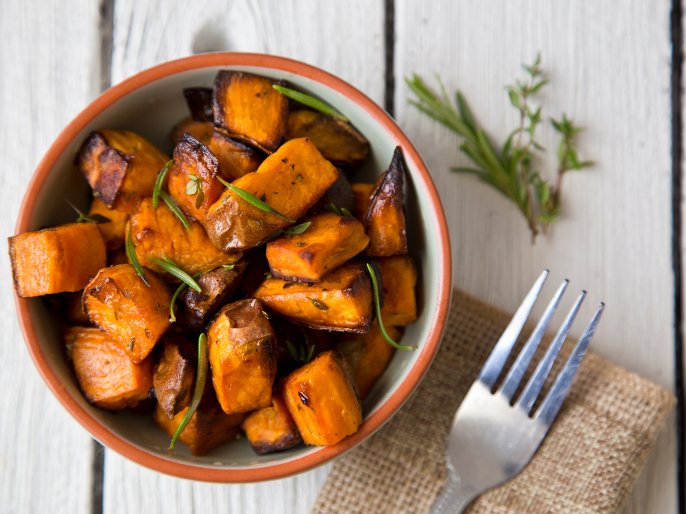 A delicious and colorful mix of roasted vegetables including sweet potatoes, carrots, and squash, seasoned with herbs and spices. 